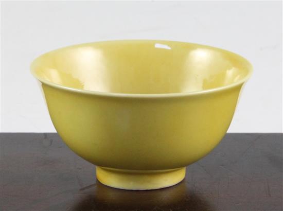 A Chinese yellow glazed small flared bowl, Kangxi six character mark and possibly of the period, diam. 9.5cm